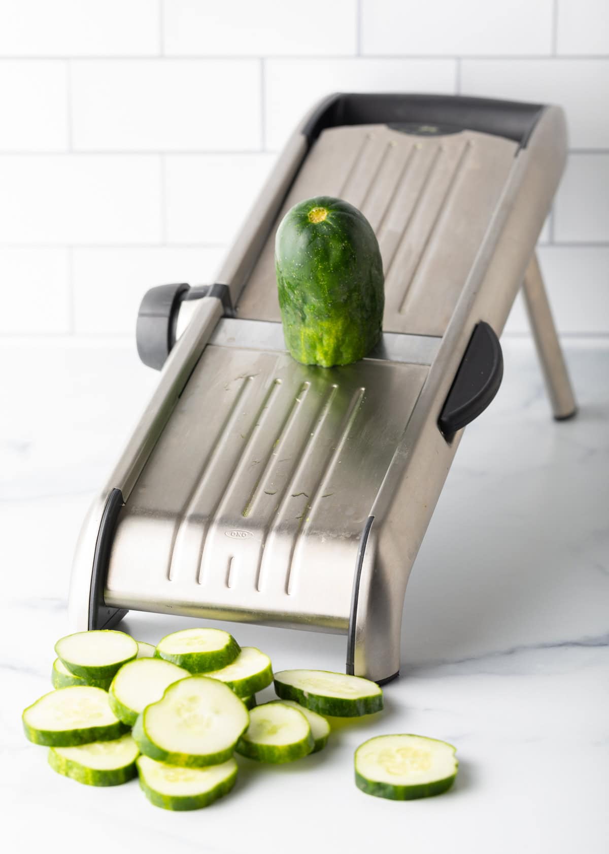 Mandolin slicer with cucumbers.
