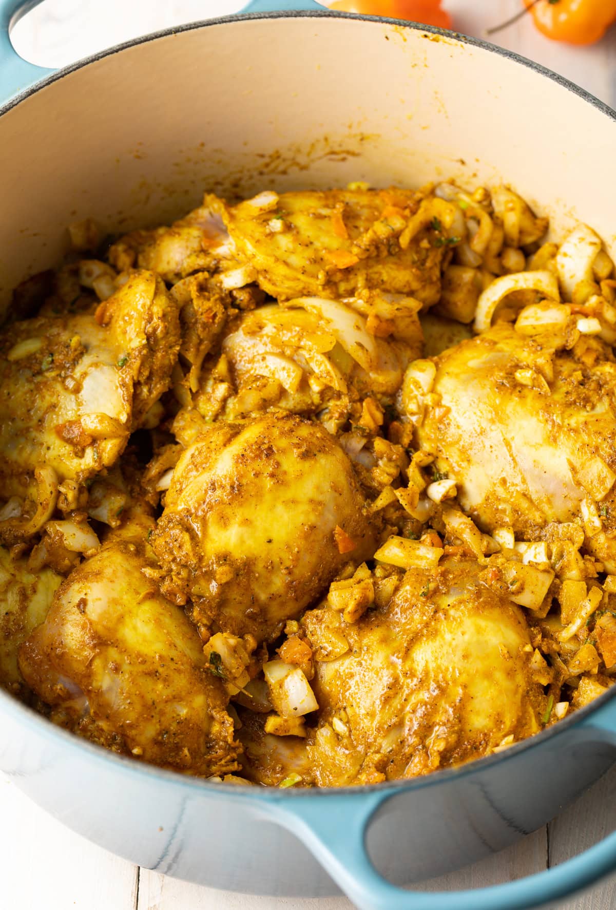 Chicken being browned in a pot.