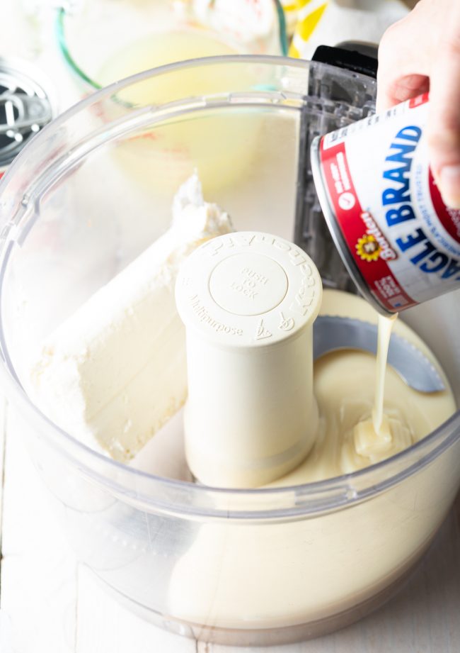 evaporated milk and cream cheese in a food processor