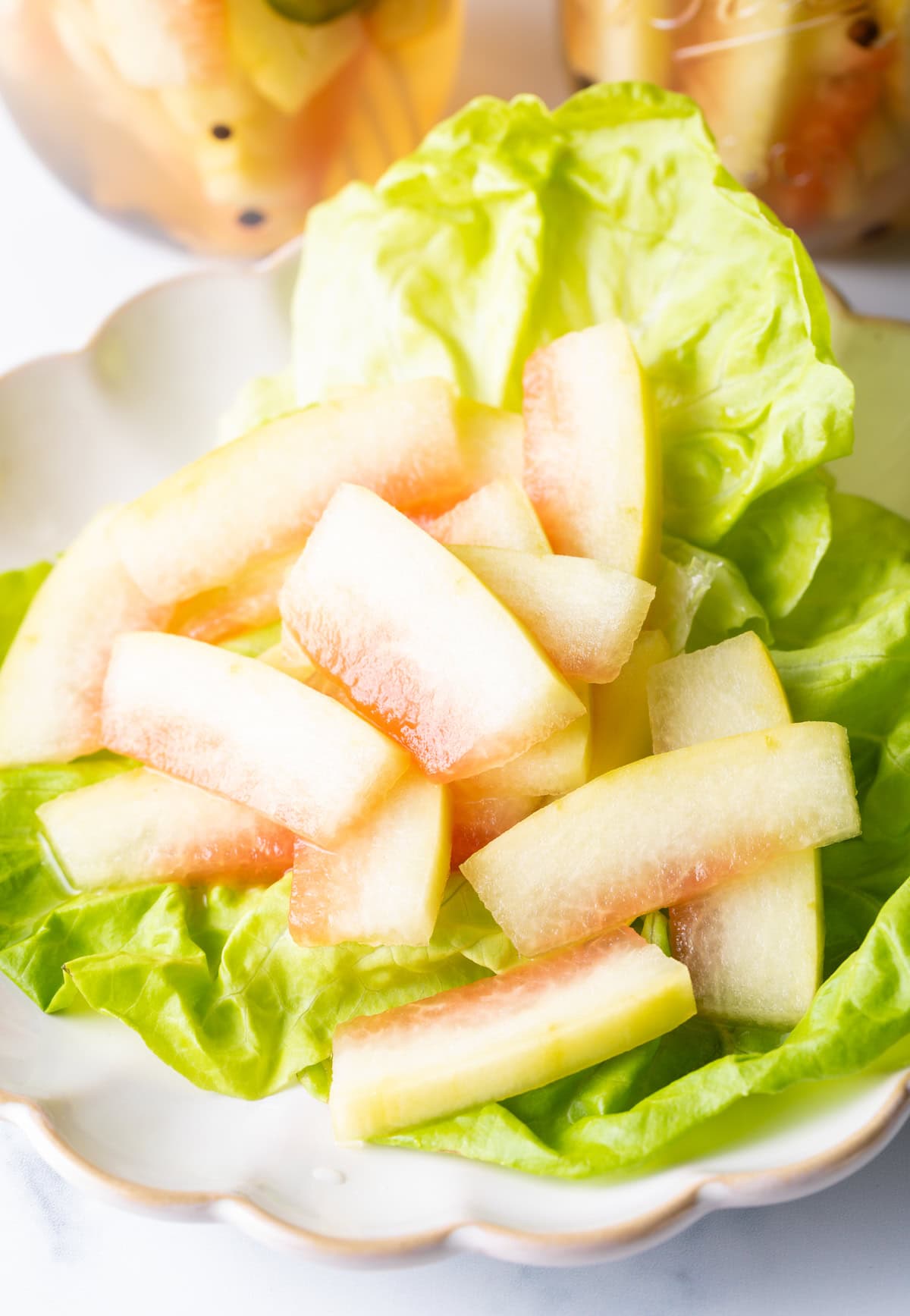 watermelon pickles on a bed of lettuce
