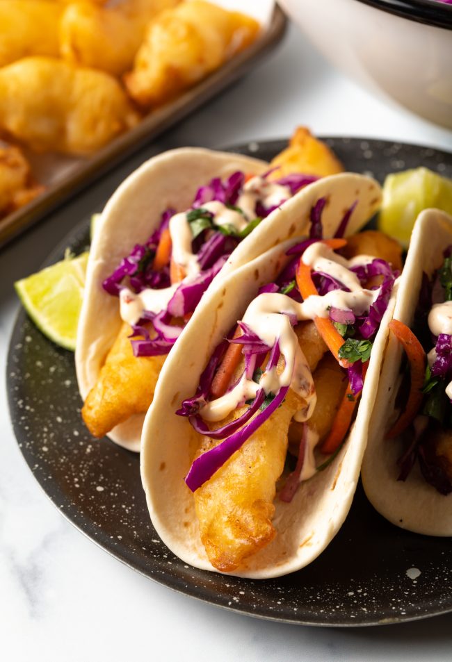 fried fish tacos with fish slaw and sauce