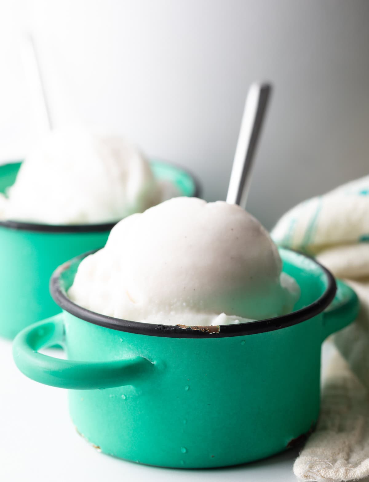 coconut milk ice cream in two small serving bowls.