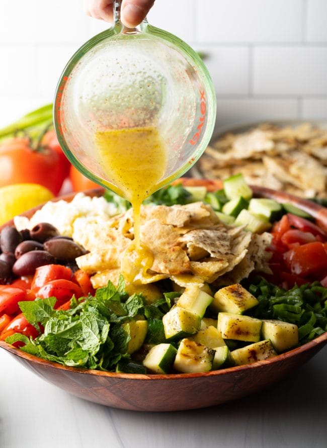 salad dressing poured over fattoush
