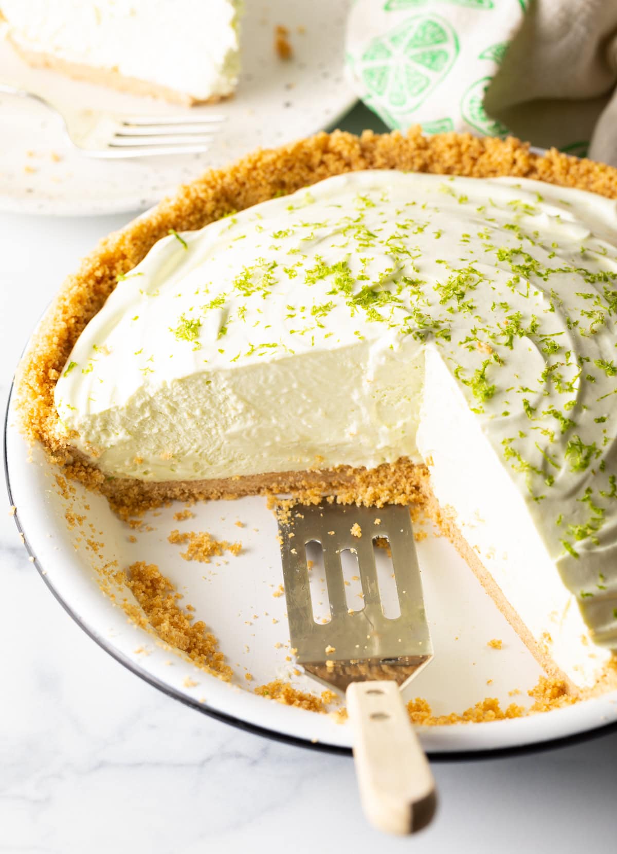 Side view of no bake key lime pie with a seriously big piece removed. 