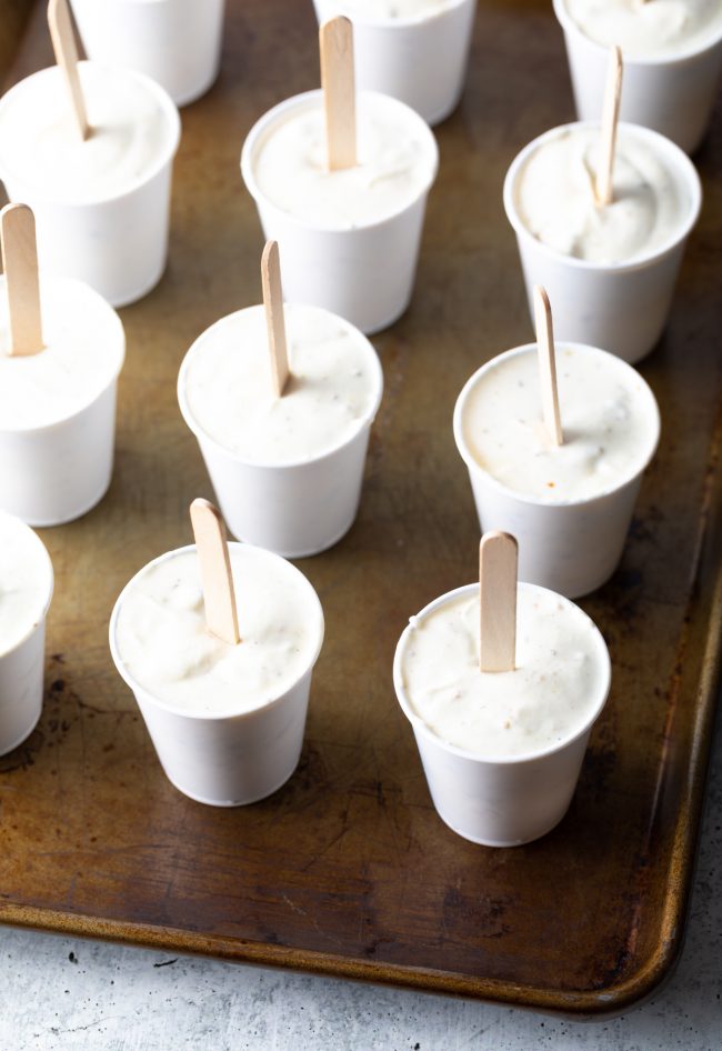 malai ice cream in cups with sticks to make popsicles