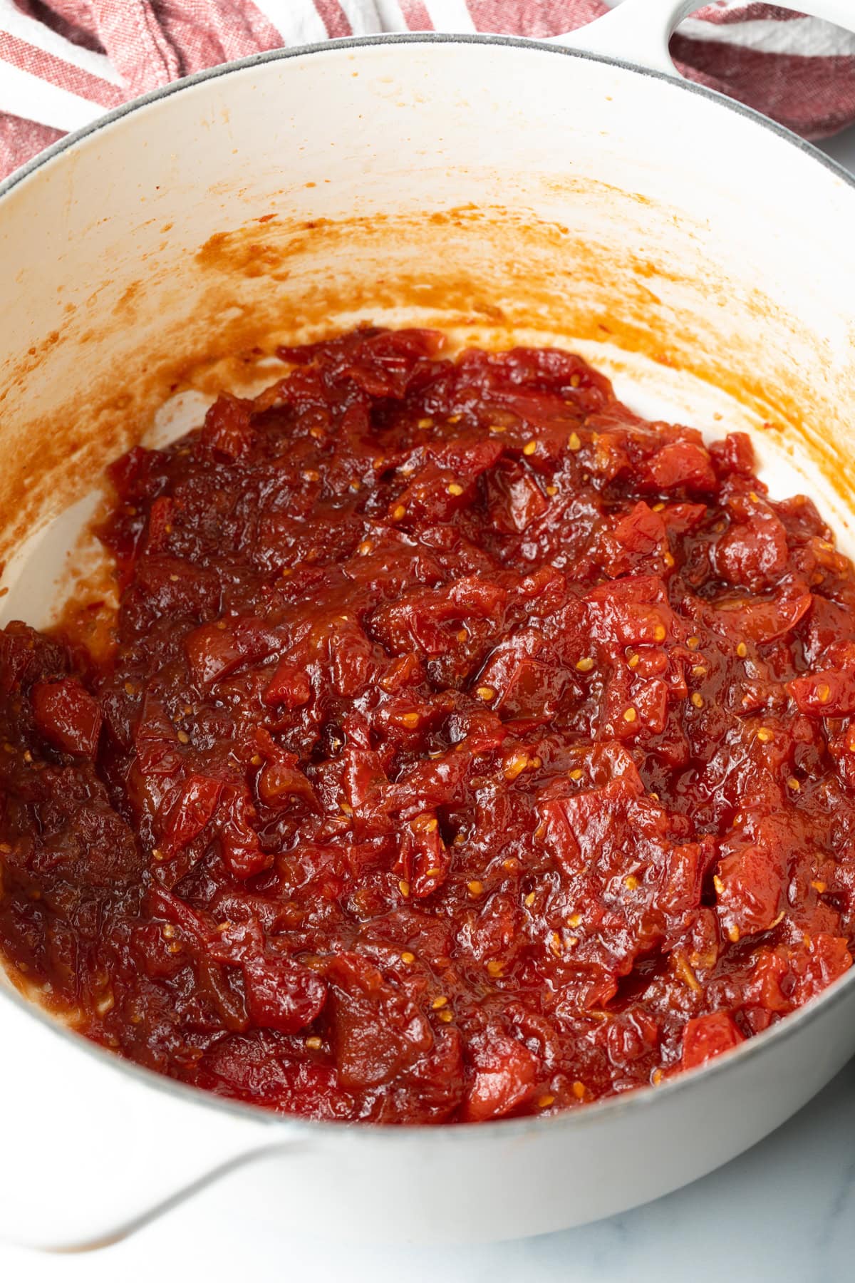 Tomato jam simmering in a pot.