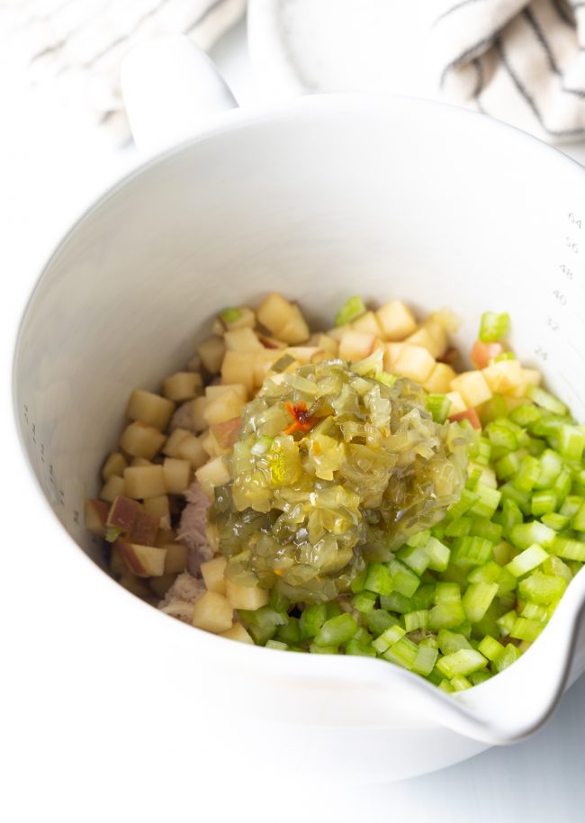 chopped apple, celery, and relish in a measuring cup