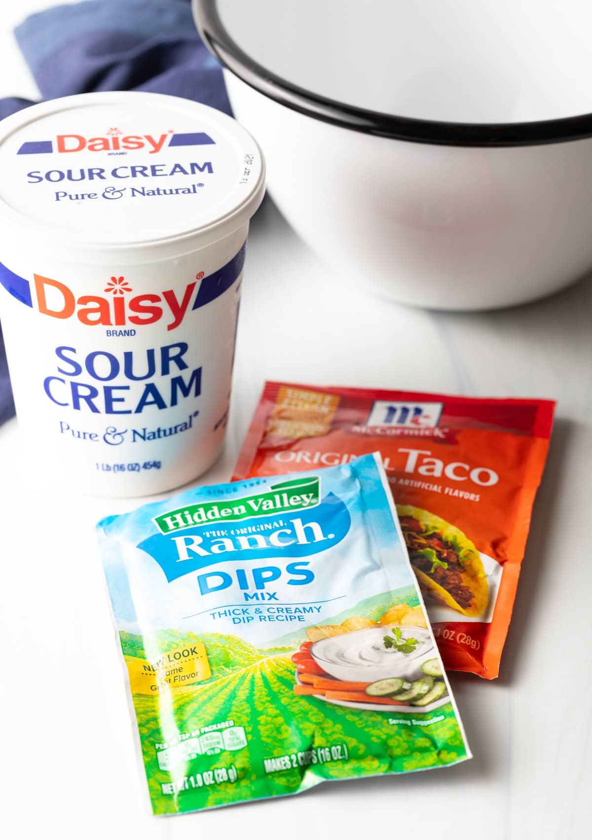 sour cream and seasoning packets on white background