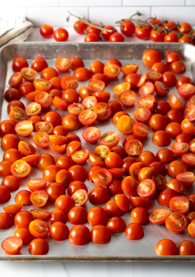 halved tomatoes on a baking sheet