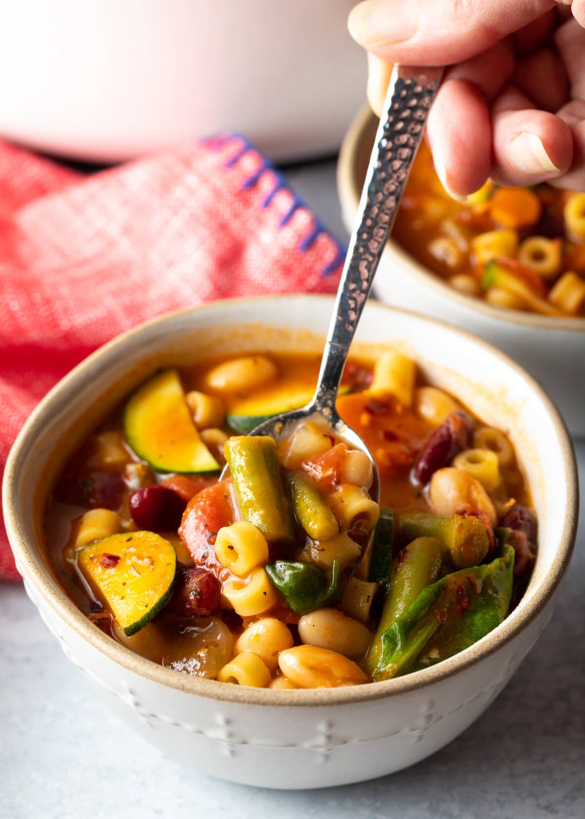 A bowl filled with minestrone soup. 