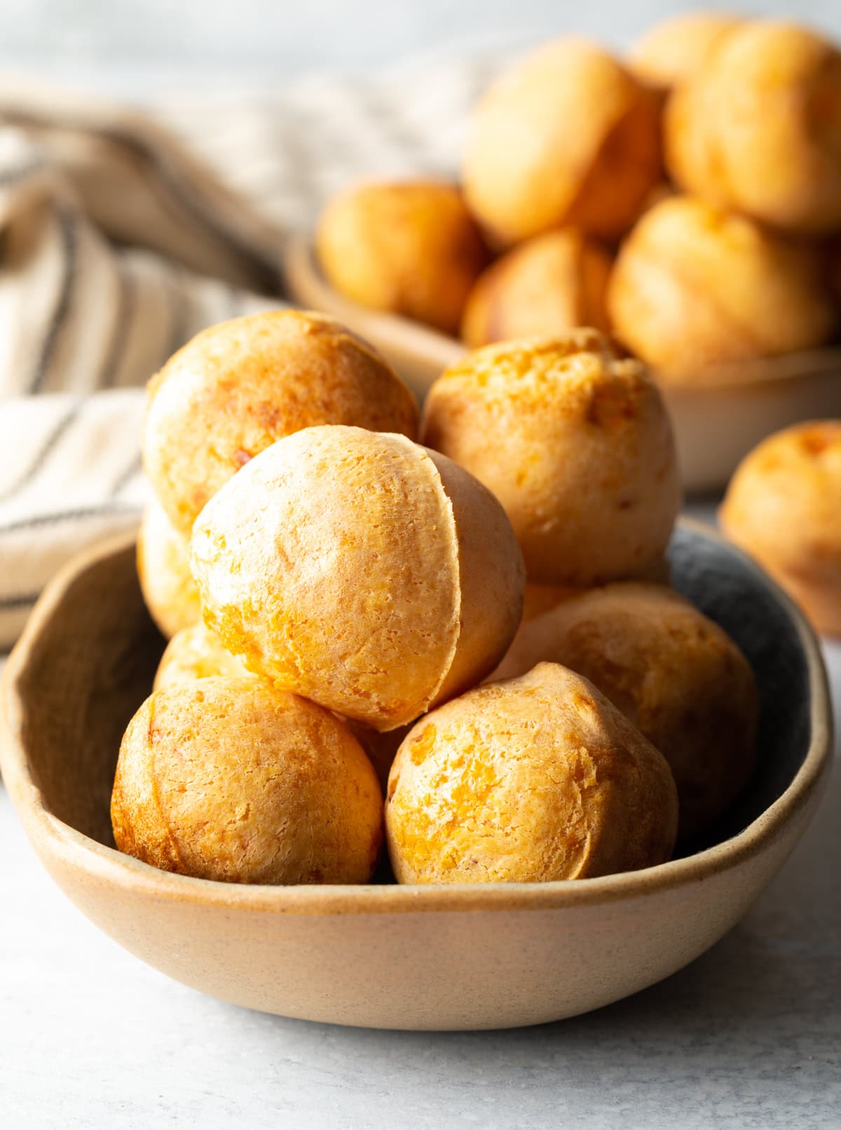 Easy keto Brazilian cheese bread stacked in a bowl.