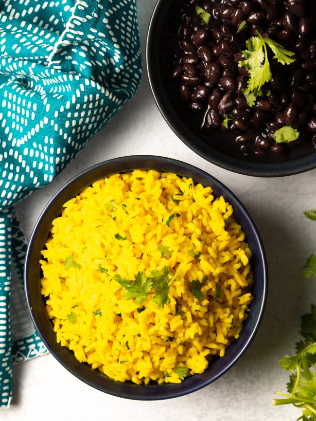 overhead view of bowl of yellow rice with black beans