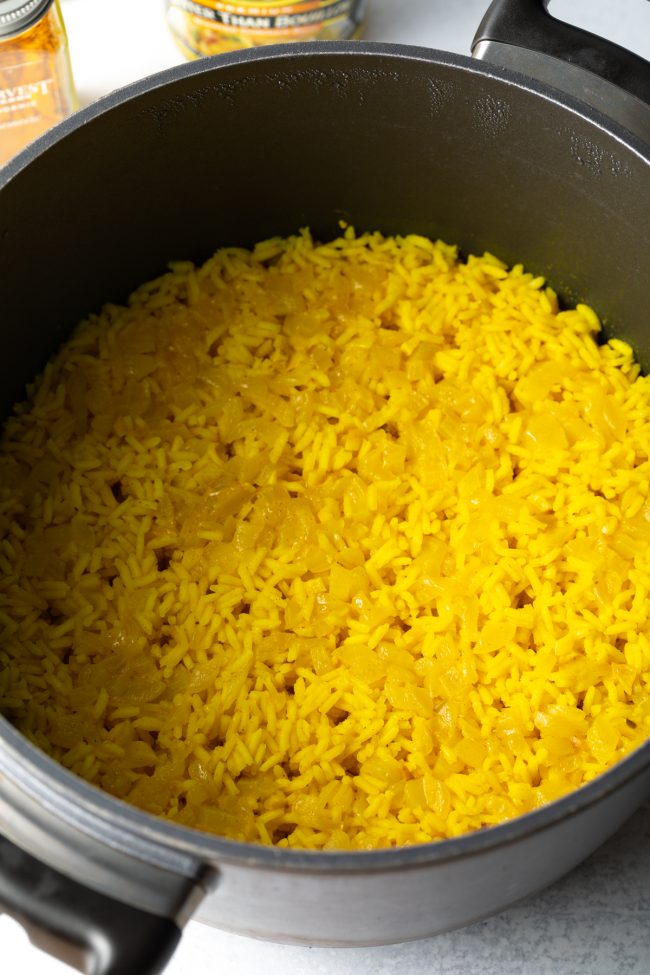 cooked arroz amarillo with steam holes