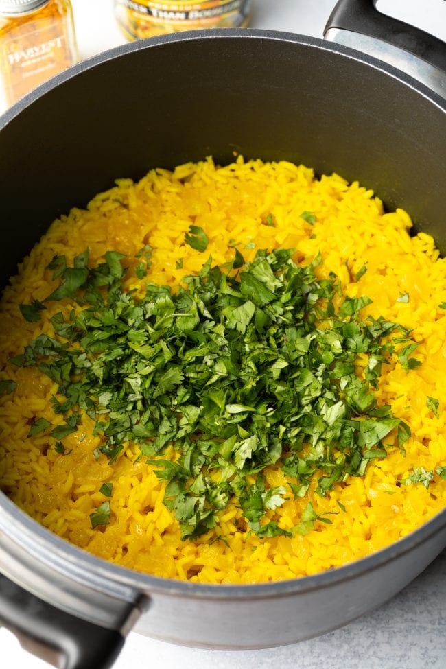 Yellow rice topped with fresh cilantro.