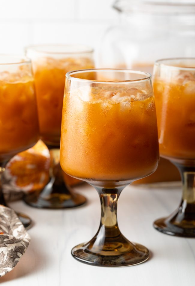 side view of goblets with iced orange pumpkin juice