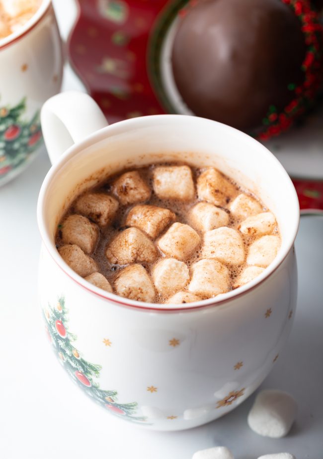 top view christmas mug filled with hot cocoa and mini marshmallows inside