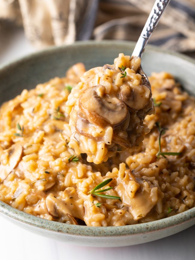spoonful of risotto with mushrooms and herbs