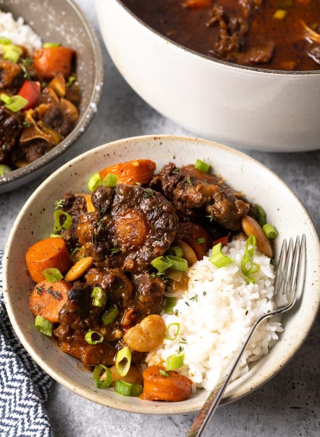 Jamaican oxtail stew recipe in a bowl with white rice.