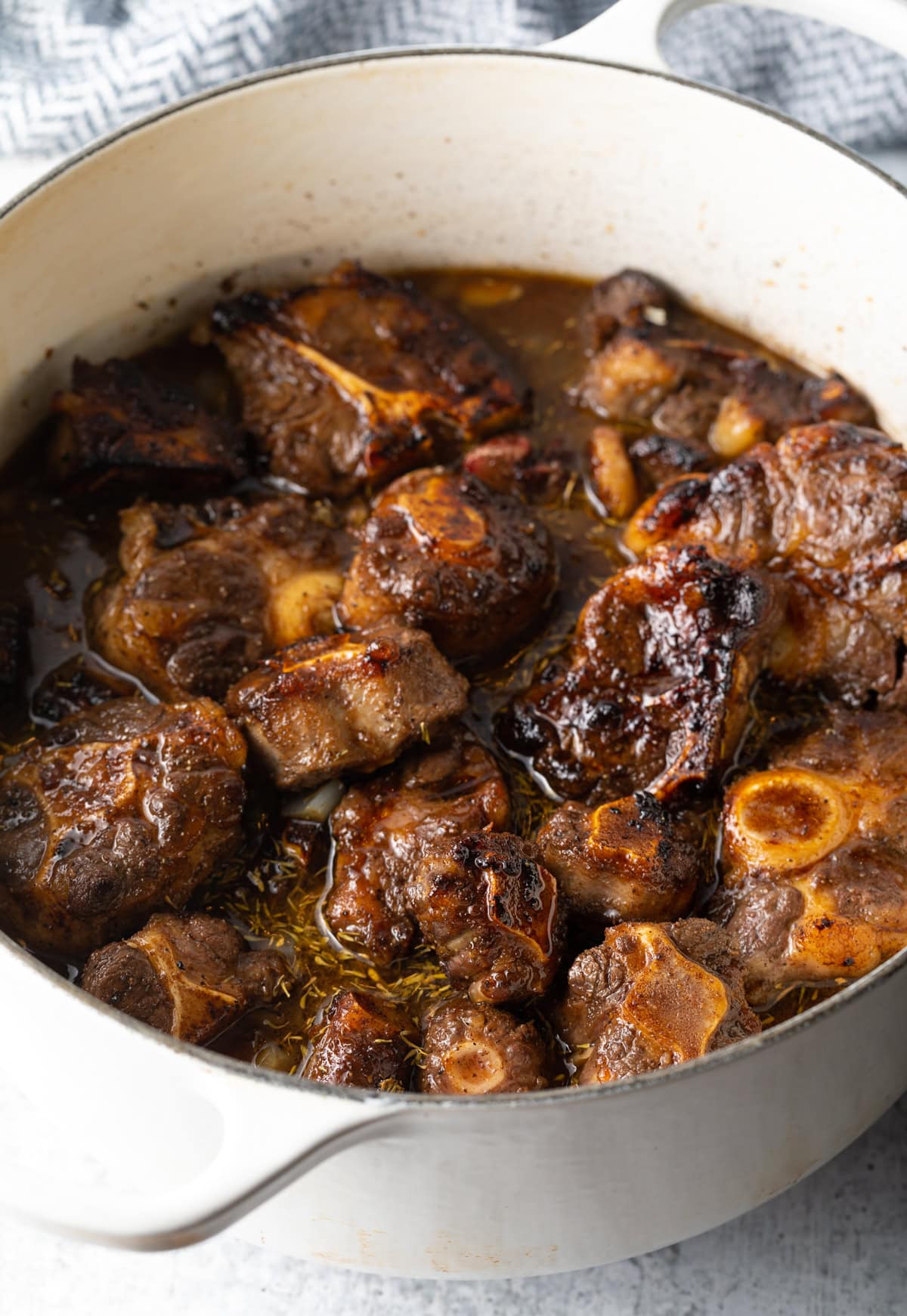Oxtail stew after simmering in a pot on the stovetop.