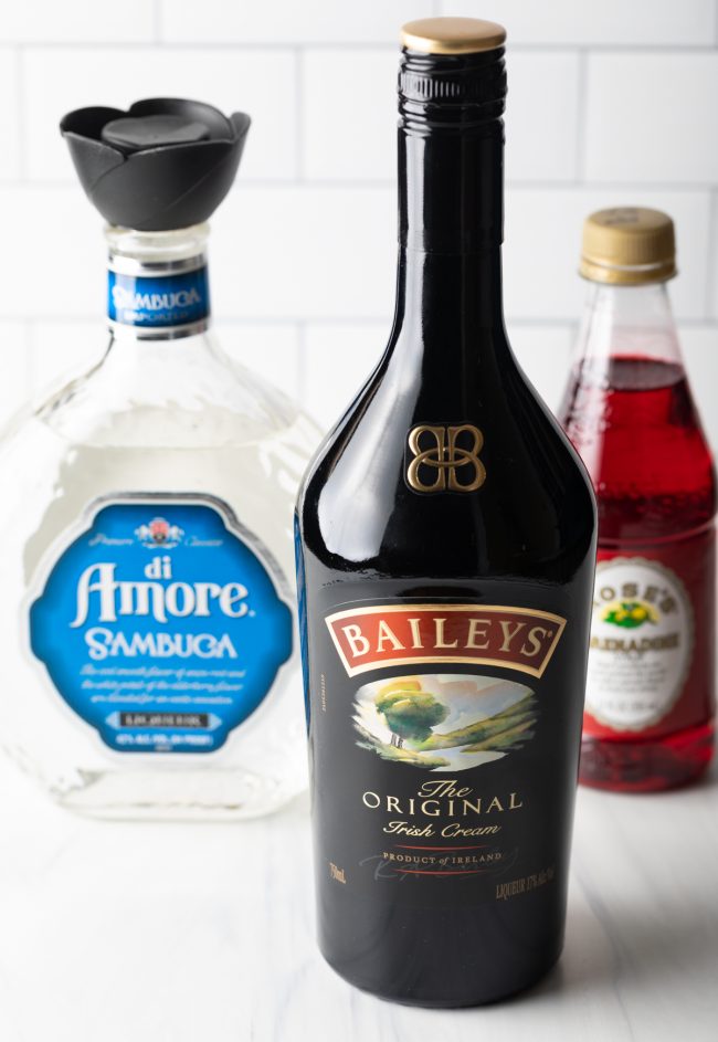 bottles of ingredients: Bailey's Irish cream, sambuca, and grenadine