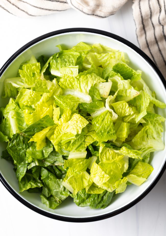 chopped romaine in a large white bowl