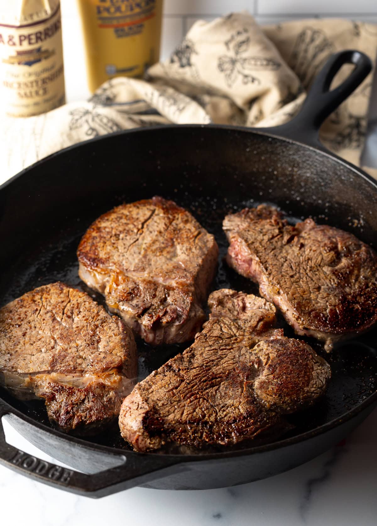 4 steaks in a cast iron skillet.