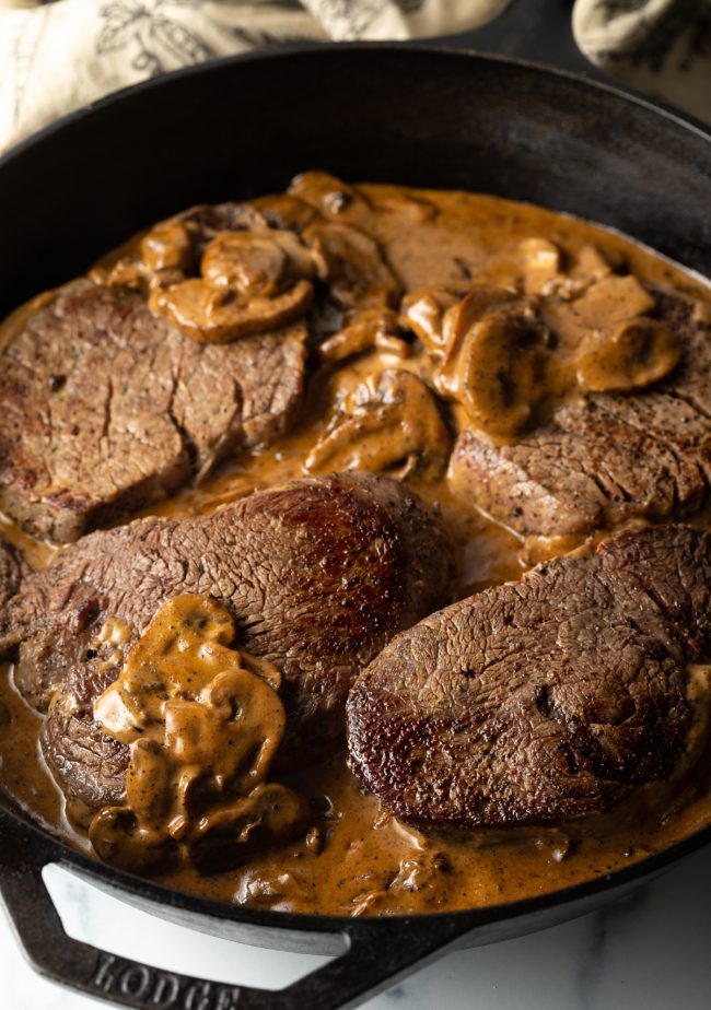 seared steaks in a cognac cream mushroom sauce