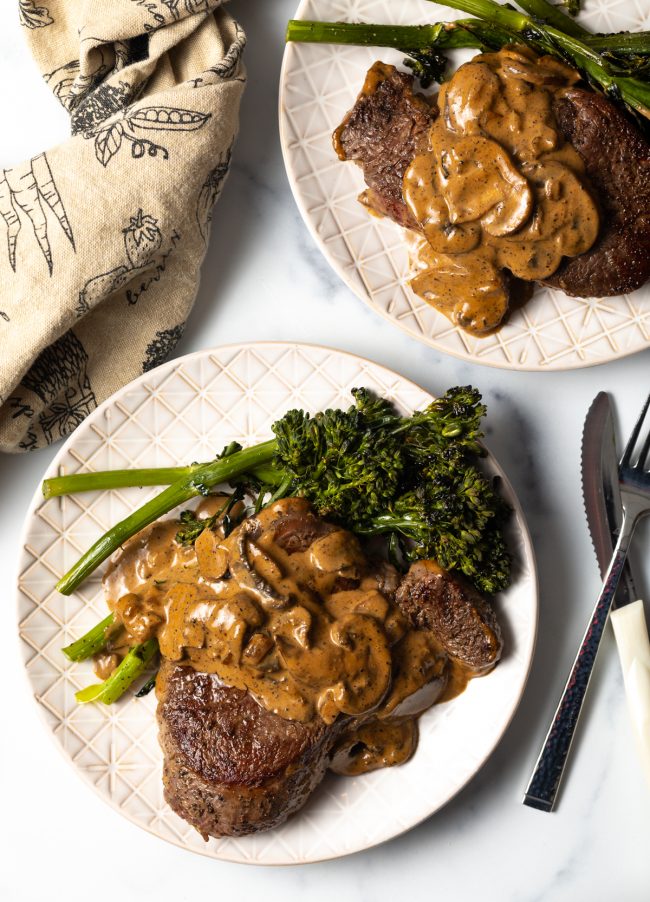 top view beef filet with mushroom cognac sauce and broccolini