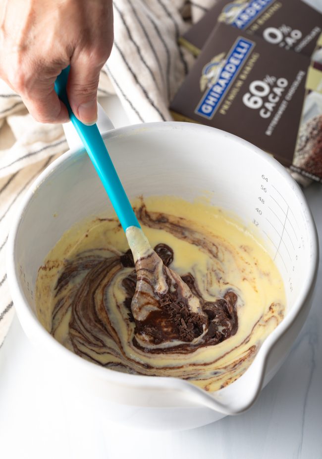 combining the ingredients in a bowl with blue spatula