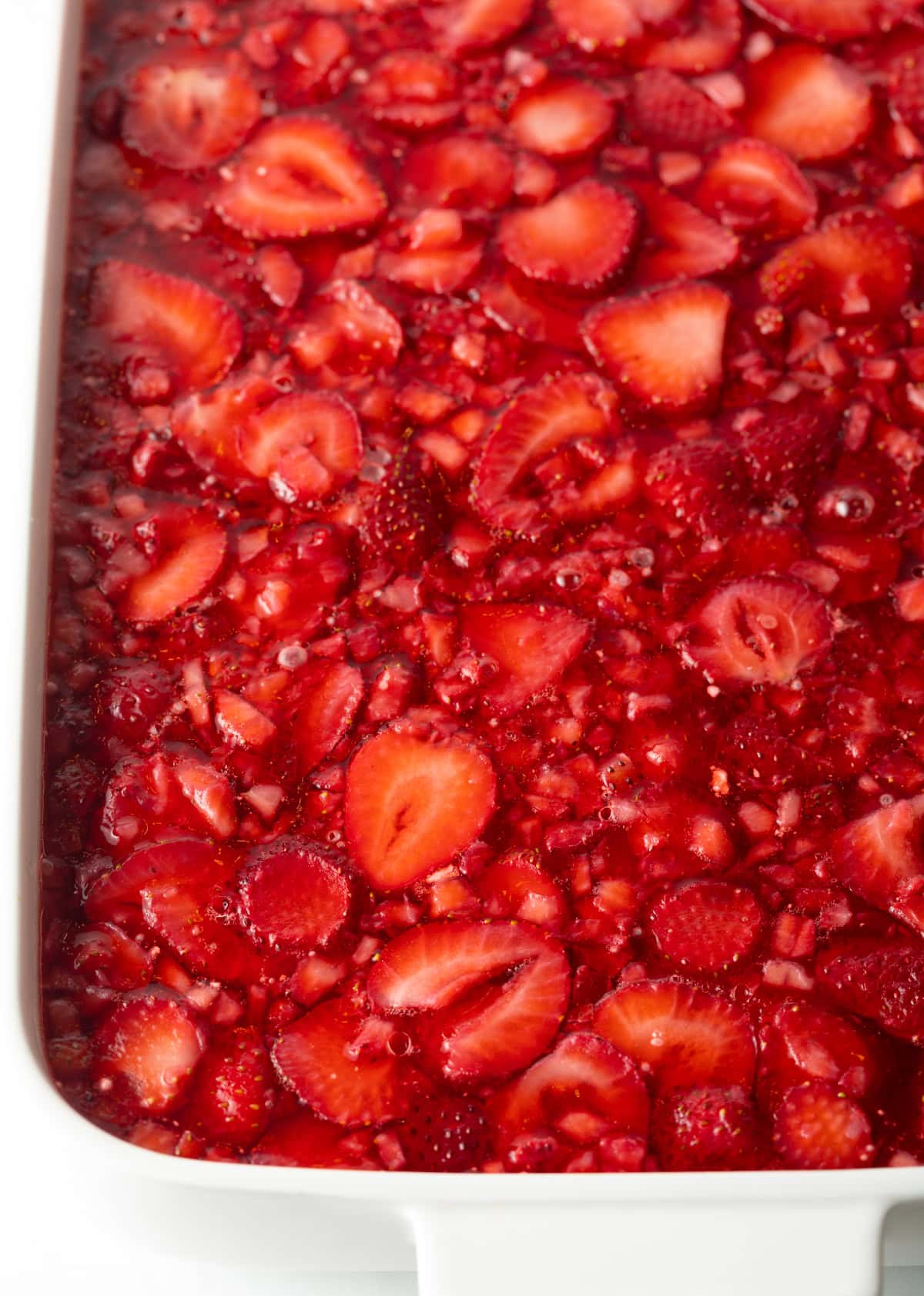 Top view chilled and solidified strawberry jello salad.