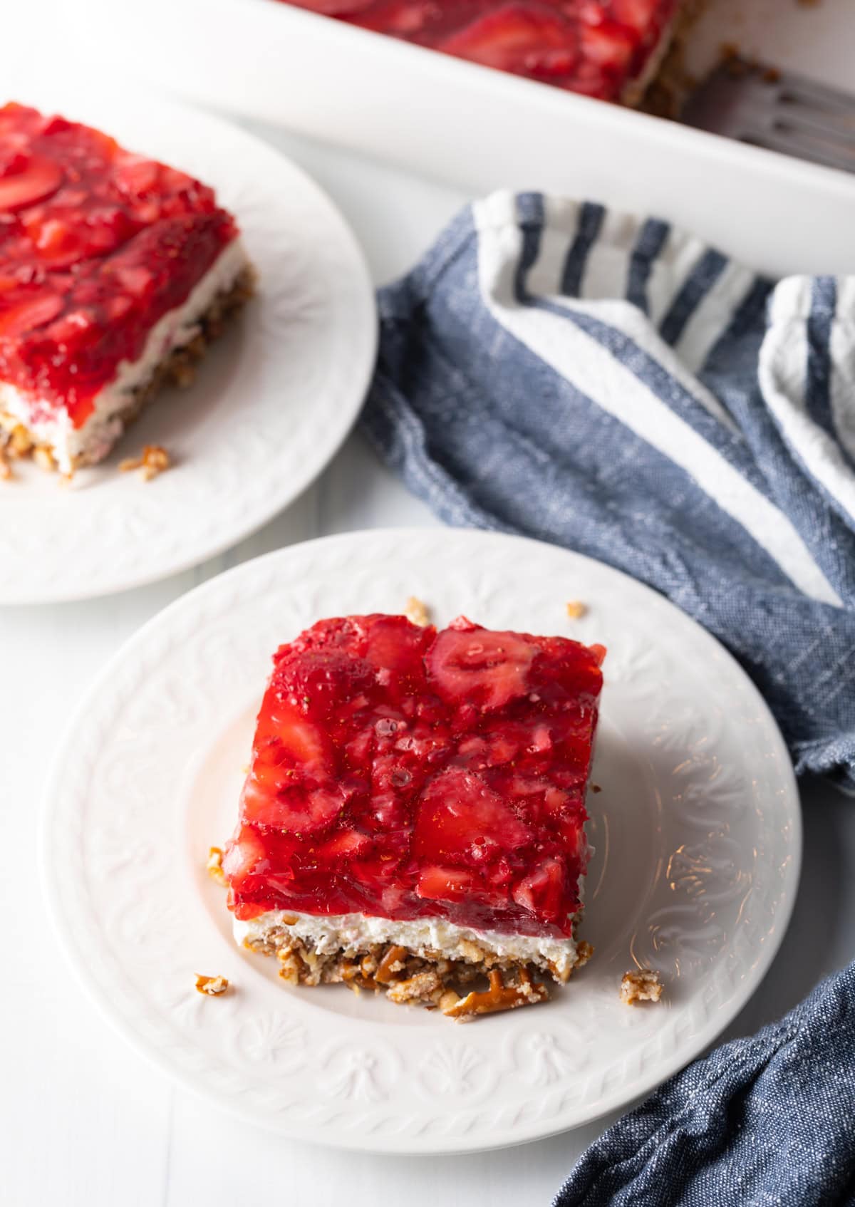 Top view strawberry jello salad with cream cheese layer and pretzel crust.