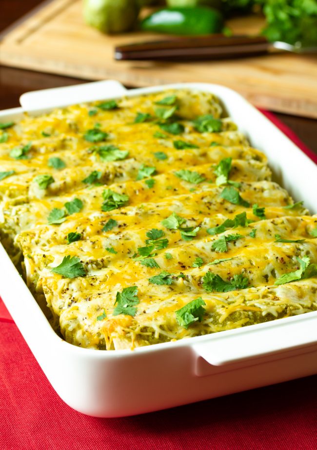 Casserole dish filled with this baked recipe covered in cheese

Chicken Enchiladas Verde Recipe