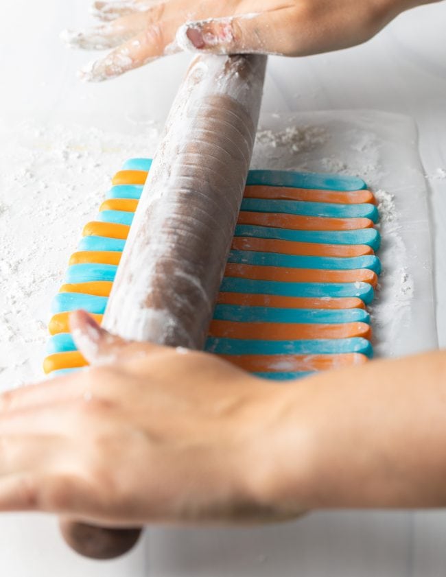 Hand rolling out fondant. 