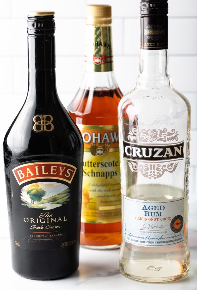 bottles of alcohol: irish cream, butterscotch schnapps, and aged rum
