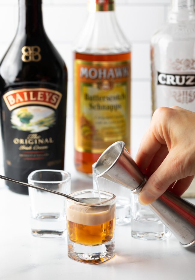 adding rum floater to the buttery nipple shot