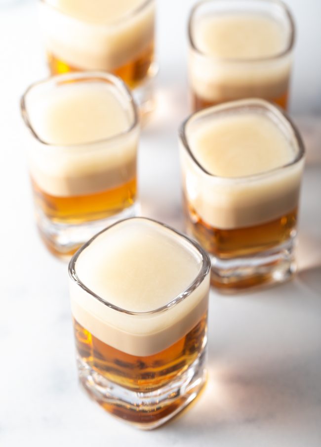 top view five shot glasses with buttery nipple coctails