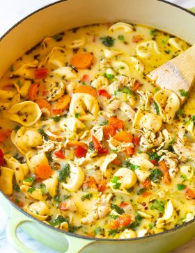 Final chicken tortellini recipe on the stove simmering in low heat