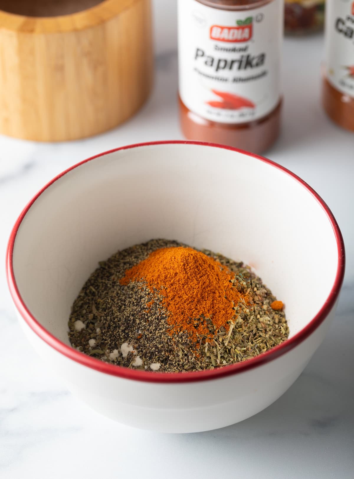 Spices added to a small bowl.