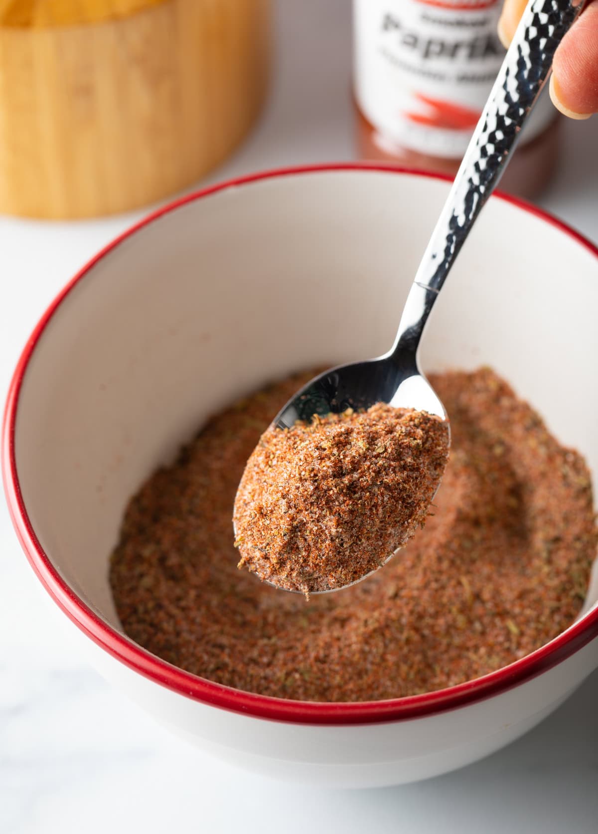 Spoon holding bit of spice blend towards camera.
