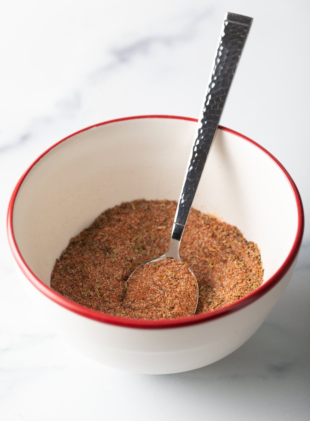 Spoon mixing spices together.