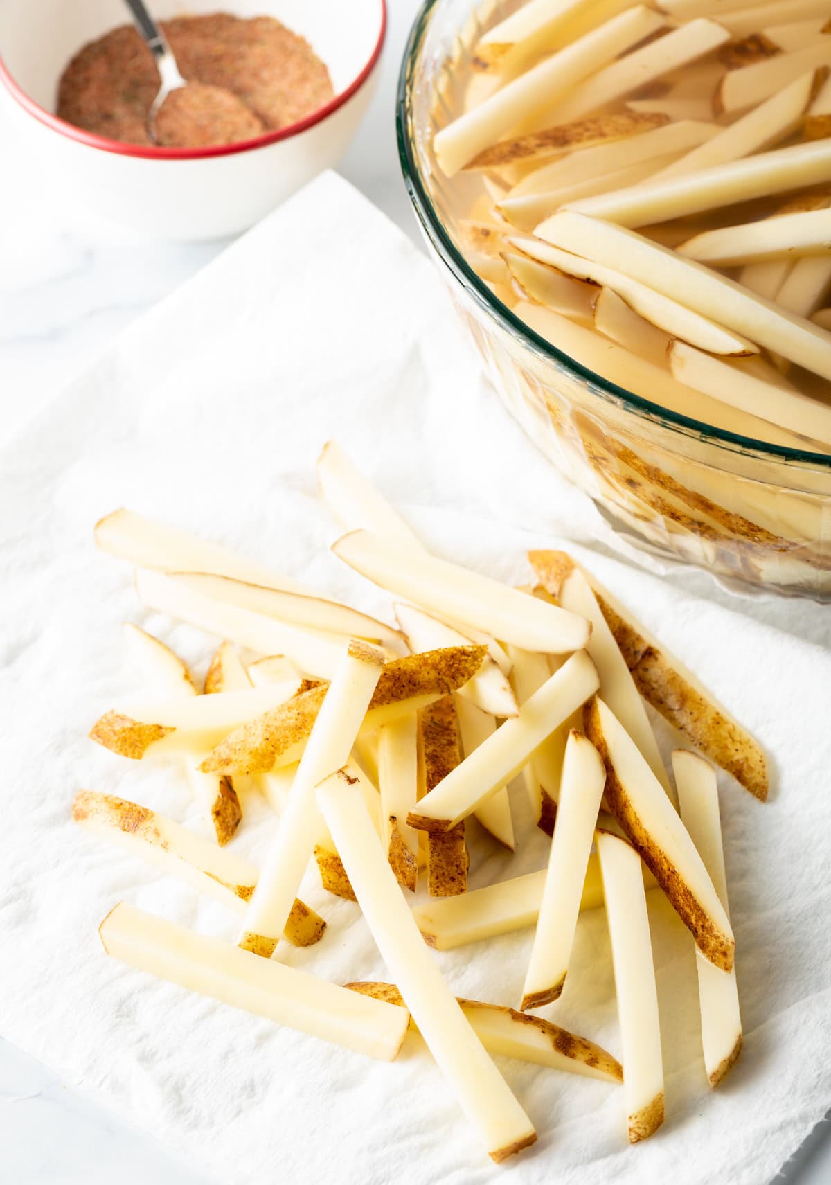 Sliced potatoes on a white towel.