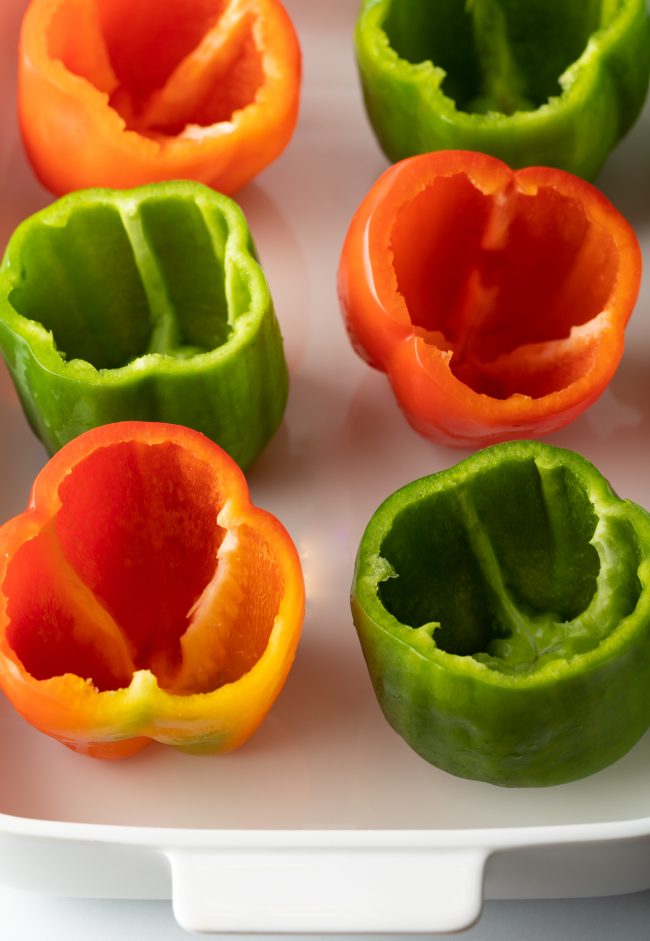 empty seeded bell peppers in a baking dish