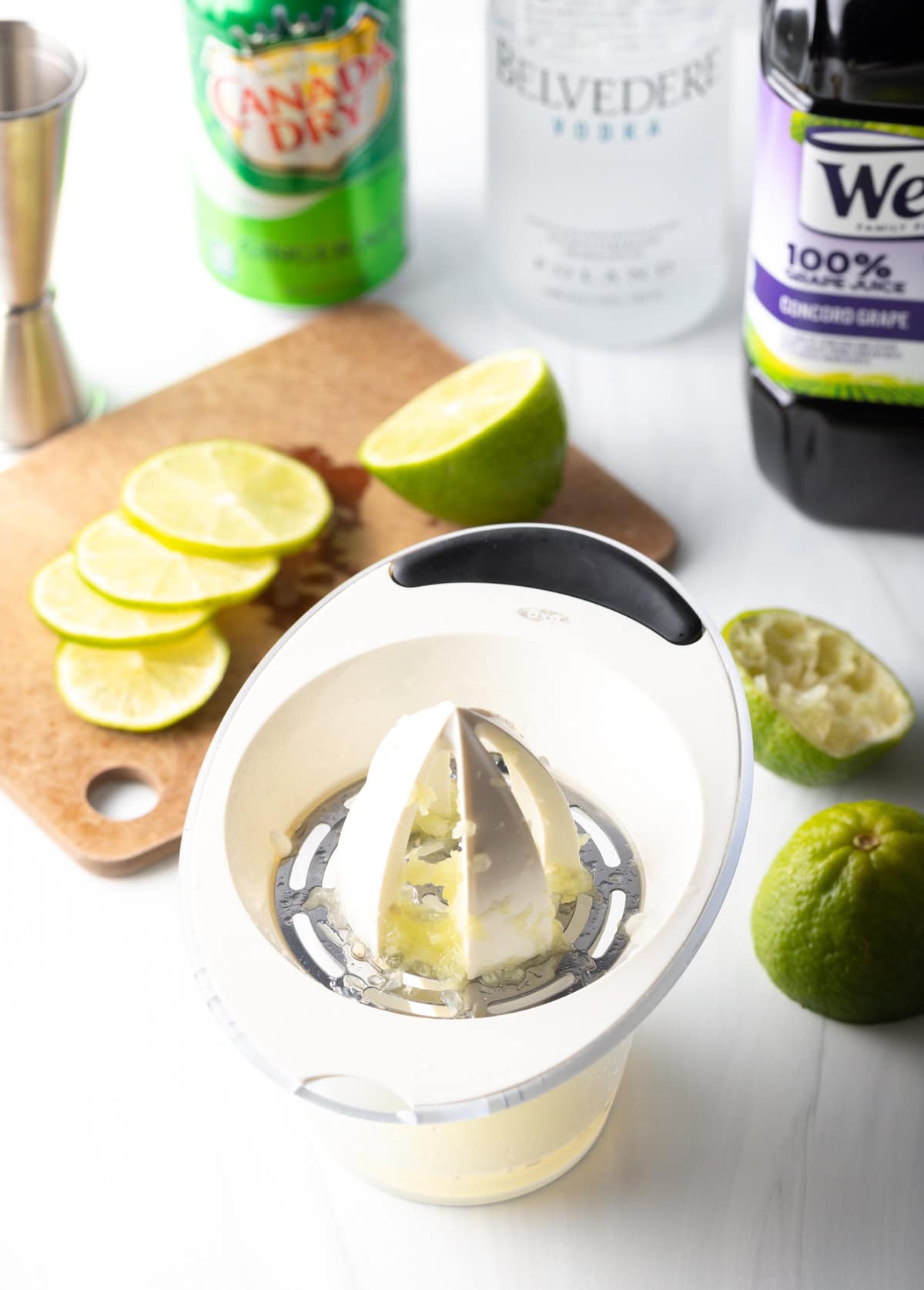 Hand juicer juicing limes.