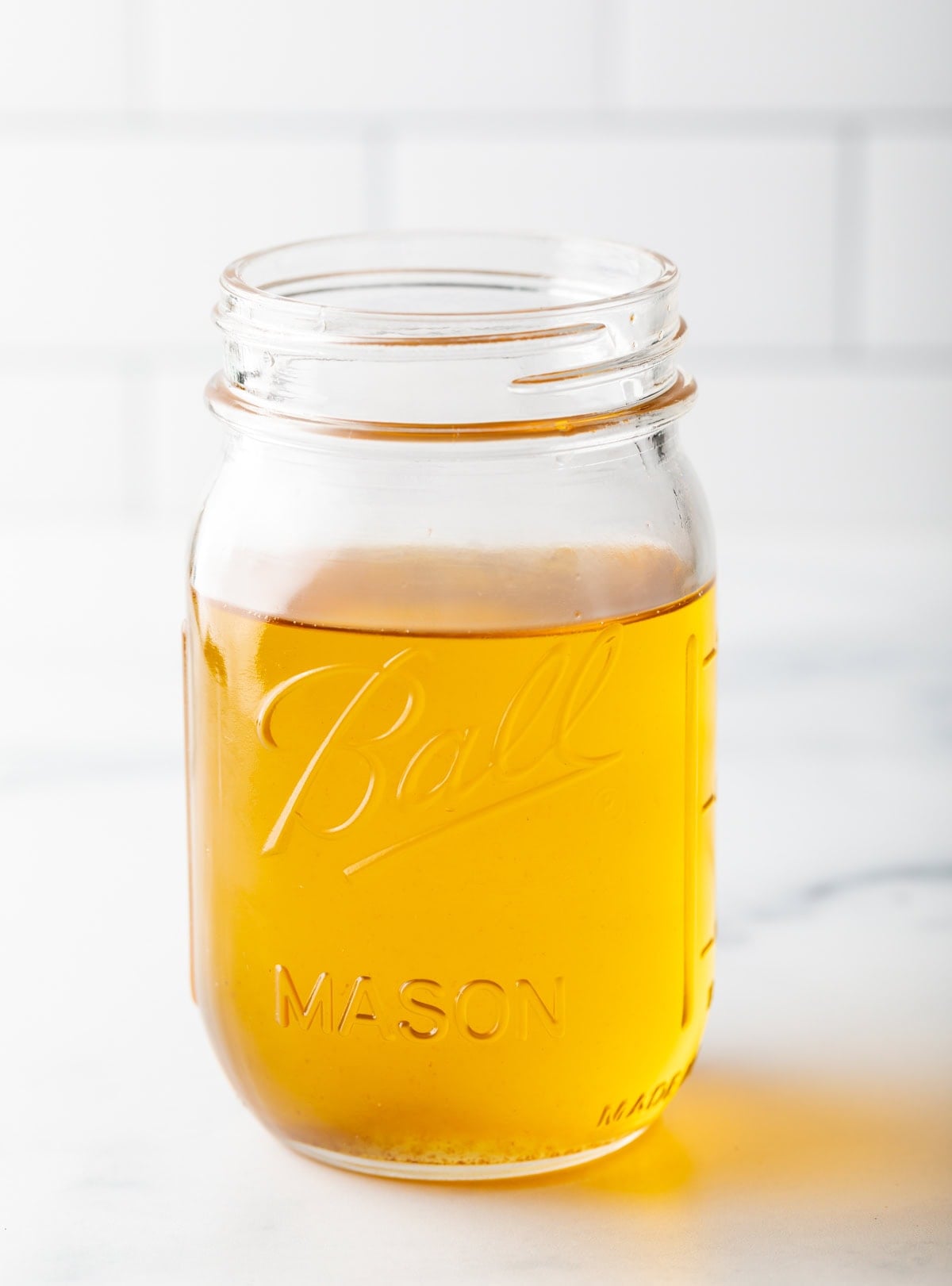 Duck fat stored in glass jar. 