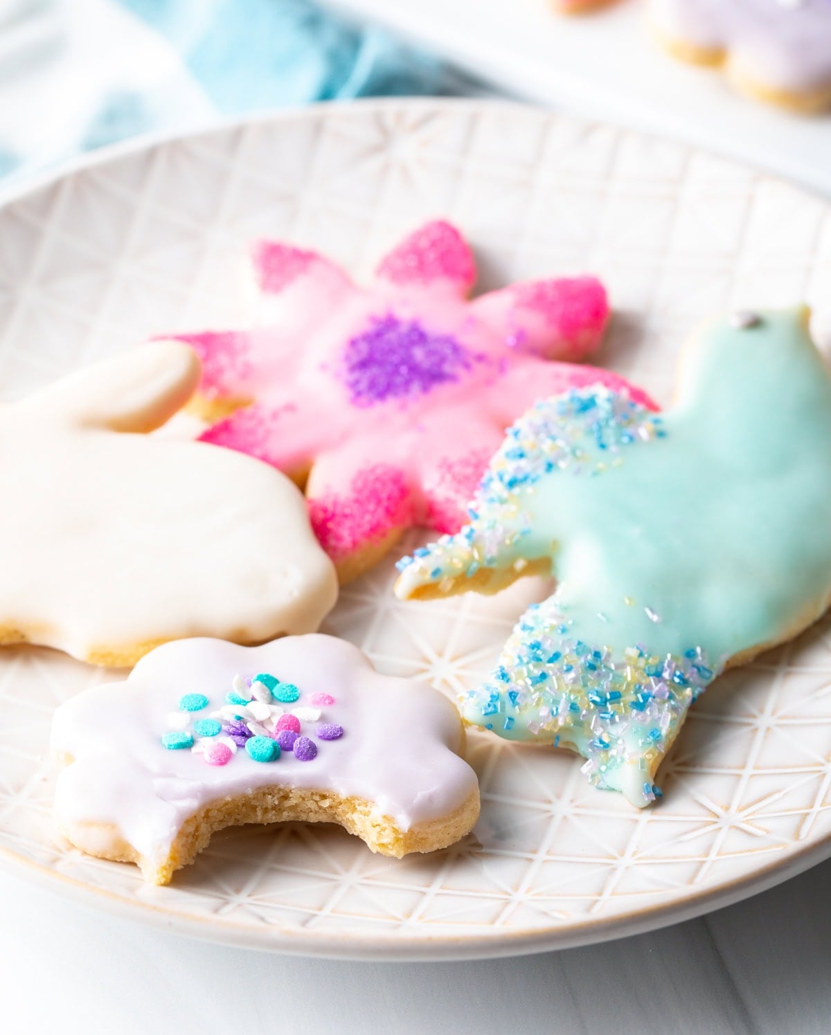 Half eaten decorated cookie on a plate. 