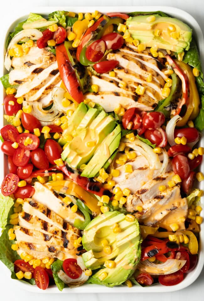 Overhead view of chicken fajita salad on a platter.