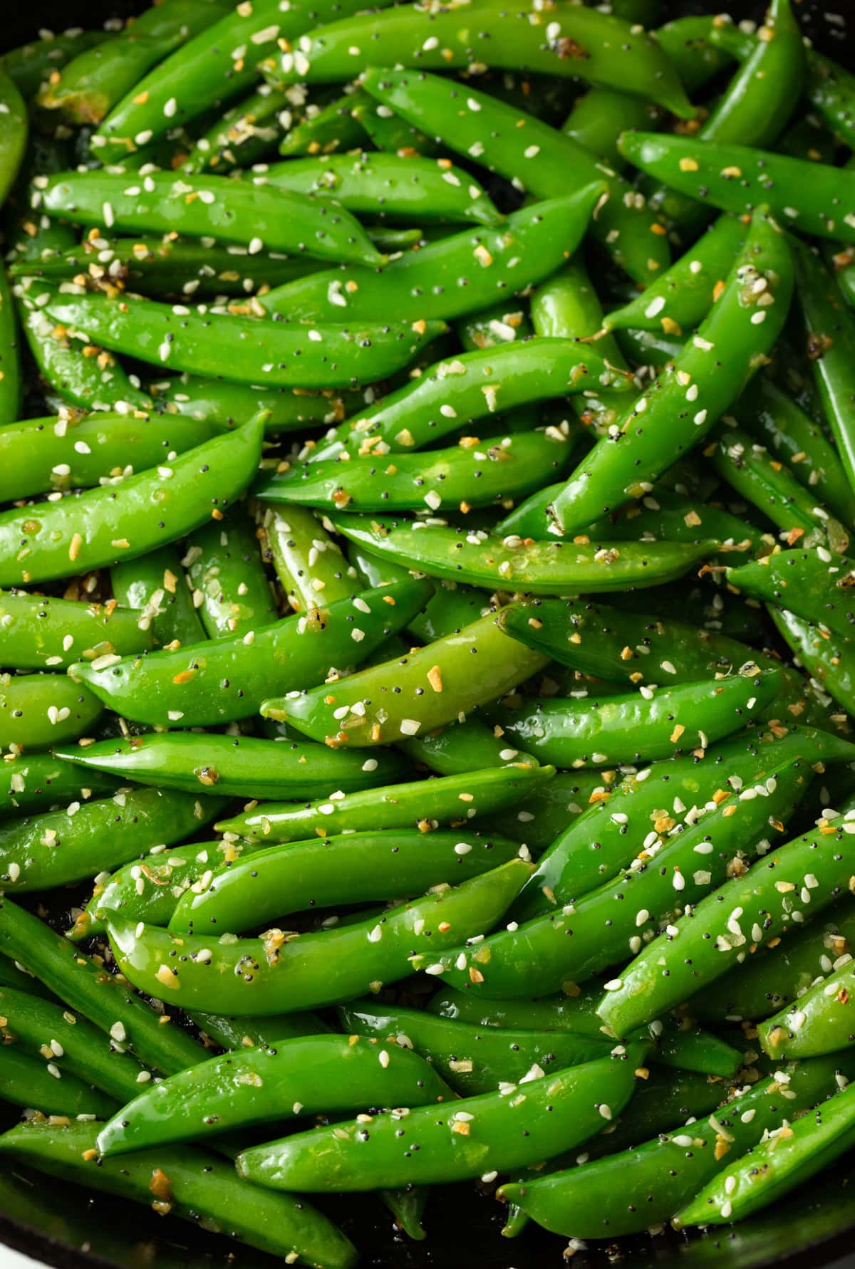 Sesame garlic stir fry snap peas - close up in large skillet