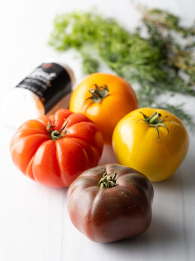 Four multicolored heirloom tomatoes.