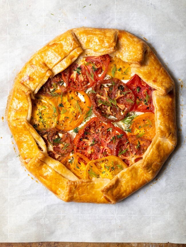 Italian tomato pie fresh from the oven, sprinkled with fresh herbs.