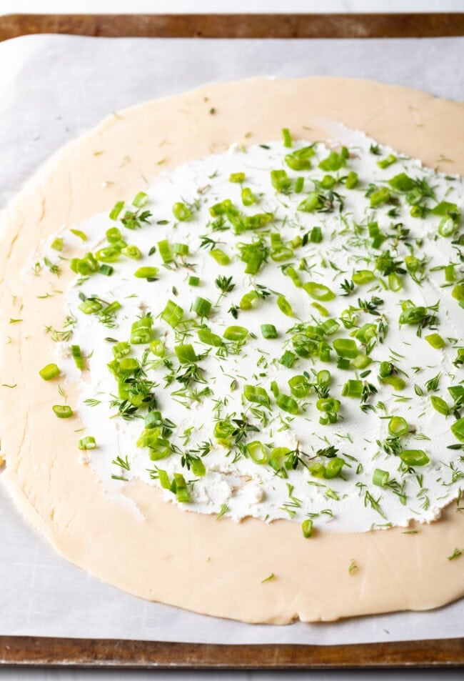 Fresh herbs sprinkled on goat cheese.
